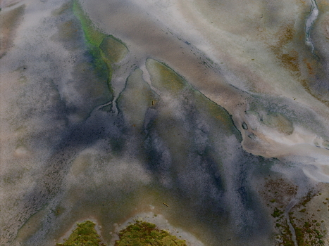 Aerial view of Abstract Tidal Patterns Culbin Sands showing intricate textures and water channels across the mudflats in Nairn Scotland United Kingdom. Aerial view of Abstract Tidal Patterns Culbin Sands showing intricate textures and water channels across the mudflats in Nairn Scotland United Kingdom.