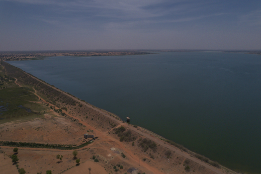 Aerial view of Minjibir Dam with its long embankment wall and surrounding arid landscape under a clear sky Kano City Kano State Nigeria. Aerial view of Minjibir Dam with its long embankment wall and surrounding arid landscape under a clear sky Kano City Kano State Nigeria.