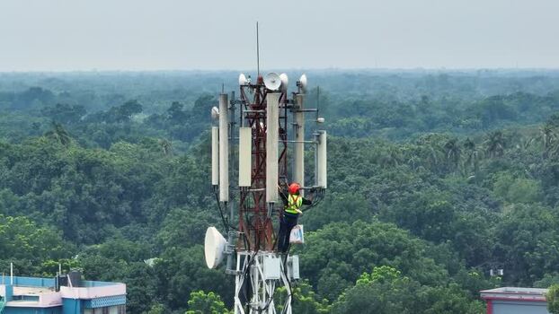 Aerial view of a technician working on a cell tower Bangladesh.