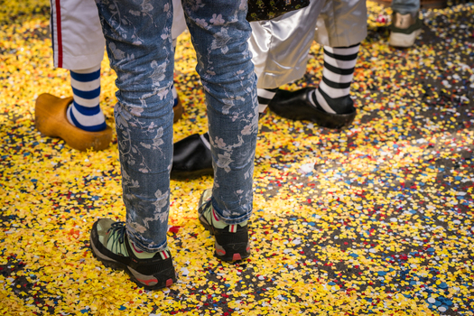Basel Switzerland 10 March 2025 View of legs and feet of costumed participants amidst a sea of vibrant yellow confetti during Fasnacht celebrations. Basel Switzerland 10 March 2025 View of legs and feet of costumed participants amidst a sea of vibrant yellow confetti during Fasnacht celebrations.