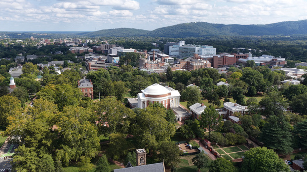 Aerial view of the historic Rotunda at the University of Virginia surrounded by lush green trees and campus buildings in Charlottesville Virginia United States. Aerial view of the historic Rotunda at the University of Virginia surrounded by lush green trees and campus buildings in Charlottesville Virginia United States.