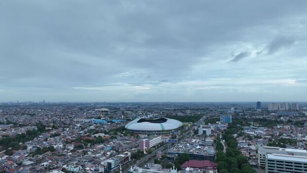 Aerial view of Patriot Candrabhaga Stadium surrounded by dense urban rooftops and city streets under an overcast sky in Kecamatan Bekasi Selatan Jawa Barat Indonesia. Aerial view of Patriot Candrabhaga Stadium surrounded by dense urban rooftops and city streets under an overcast sky in Kecamatan Bekasi Selatan Jawa Barat Indonesia.
