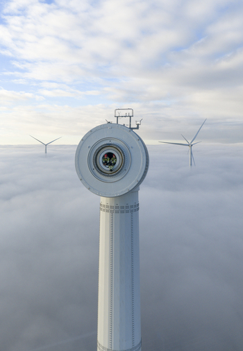 Netherlands 26 November 2025 Aerial view of a wind turbine nacelle with workers inside rising above a thick layer of fog under a blue sky. Netherlands 26 November 2025 Aerial view of a wind turbine nacelle with workers inside rising above a thick layer of fog under a blue sky.