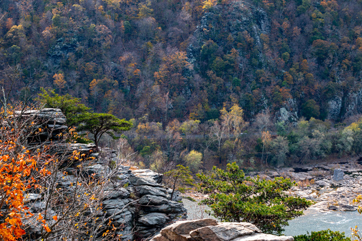 Harpers Ferry West Virginia United States 16 November 2019 Aerial view of the Potomac River flowing through rugged cliffs and dense autumn forest featuring vibrant fall foliage. Harpers Ferry West Virginia United States 16 November 2019 Aerial view of the Potomac River flowing through rugged cliffs and dense autumn forest featuring vibrant fall foliage.