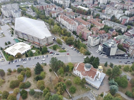 Aerial view of Universiada Hall and the surrounding urban landscape with a church park and city streets in Sofia Sofia City Province Bulgaria.
