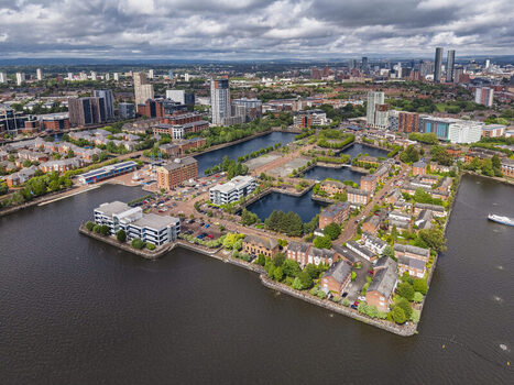 Aerial view of MediaCityUK featuring modern office buildings residential complexes and waterfront docks surrounded by urban infrastructure in Salford England United Kingdom. Aerial view of MediaCityUK featuring modern office buildings residential complexes and waterfront docks surrounded by urban infrastructure in Salford England United Kingdom.