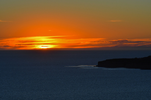 View of the sunset over the Atlantic Ocean with the silhouette of the coastline at Puerto Piramides in Puerto Madryn Chubut Argentina. View of the sunset over the Atlantic Ocean with the silhouette of the coastline at Puerto Piramides in Puerto Madryn Chubut Argentina.