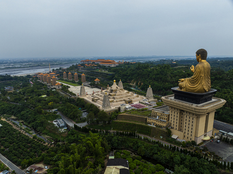 Aerial view of the Great Buddha statue and the Fo Guang Shan Buddha Museum complex with pagodas and lush greenery in Dashu District Kaohsiung Taiwan. Aerial view of the Great Buddha statue and the Fo Guang Shan Buddha Museum complex with pagodas and lush greenery in Dashu District Kaohsiung Taiwan.