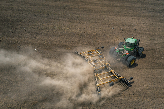 Aerial view of a tractor with a harrow raising dust clouds as it tills the fields Chyhyryns kyi district Cherkasy Oblast Ukraine. Aerial view of a tractor with a harrow raising dust clouds as it tills the fields Chyhyryns kyi district Cherkasy Oblast Ukraine.