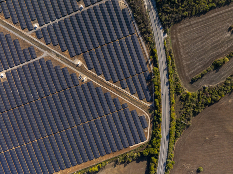 Aerial view of a large solar farm with rows of photovoltaic panels arranged in geometric patterns next to a road and agricultural fields in Lovech Lovech Bulgaria. Aerial view of a large solar farm with rows of photovoltaic panels arranged in geometric patterns next to a road and agricultural fields in Lovech Lovech Bulgaria.