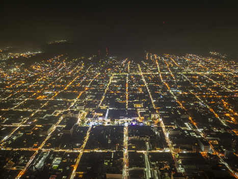 Aerial view of the illuminated city grid of Uruapan at night showcasing the dense network of streets and buildings glowing under artificial lights. Uruapan Michoacan Mexico. Aerial view of the illuminated city grid of Uruapan at night showcasing the dense network of streets and buildings glowing under artificial lights. Uruapan Michoacan Mexico.