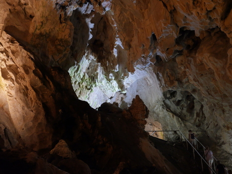 View of Vrelo Cave featuring intricate stalactites and stalagmites with visitors walking along a metal staircase in Matka Komuna e Sopishtes North Macedonia.