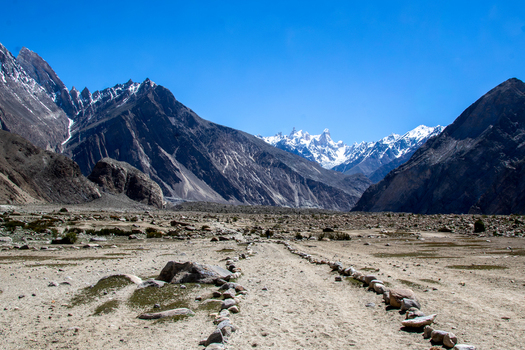 View of K2 Base Camp with rocky terrain and snow capped mountains under a clear blue sky in Ghakhar Gilgit Pakistan. View of K2 Base Camp with rocky terrain and snow capped mountains under a clear blue sky in Ghakhar Gilgit Pakistan.