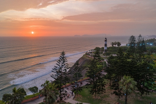 Aerial view of La Marina Lighthouse during a vibrant golden hour sunset overlooking the Pacific Ocean coastline and cliffs in Miraflores Lima Province Peru. Aerial view of La Marina Lighthouse during a vibrant golden hour sunset overlooking the Pacific Ocean coastline and cliffs in Miraflores Lima Province Peru.