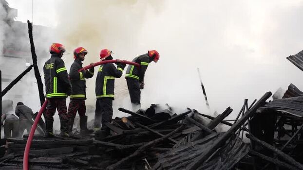 View of firefighters extinguishing a fire in Khagrachari Bangladesh. View of firefighters extinguishing a fire in Khagrachari Bangladesh.