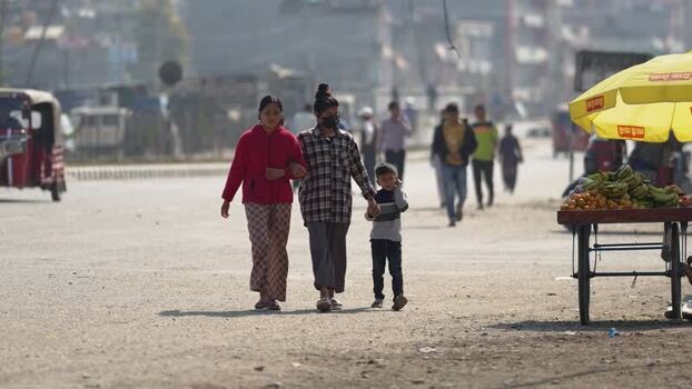 View of people walking on a dusty street in Dhangadhi Nepal. View of people walking on a dusty street in Dhangadhi Nepal.