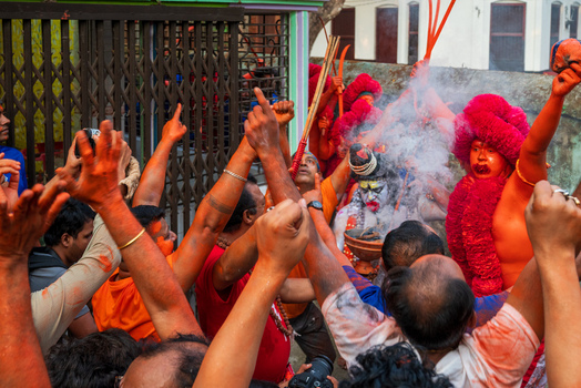 Munshiganj Bangladesh 13 April 2026 View of Hindu devotees celebrating a traditional festival with a man dressed as Lord Shiva amidst smoke and a crowd with raised hands.
