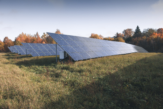 View of a solar park with rows of photovoltaic panels set in a grassy field against a backdrop of autumn trees in Otepaa Valga County Estonia. View of a solar park with rows of photovoltaic panels set in a grassy field against a backdrop of autumn trees in Otepaa Valga County Estonia.