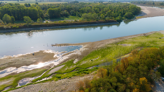 Aerial view of the Po River with low water levels caused by a summer heatwave and drought exposing sandy riverbed sediments and beaches in Castelvetro Piacentino Emilia Romagna Italy. Aerial view of the Po River with low water levels caused by a summer heatwave and drought exposing sandy riverbed sediments and beaches in Castelvetro Piacentino Emilia Romagna Italy.