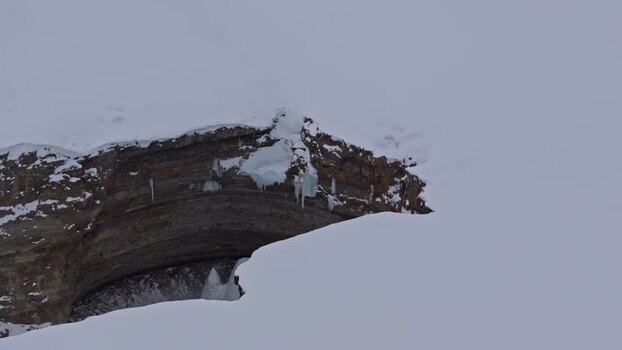 Aerial view of snowy cliff face in Pyramiden Svalbard and Jan Mayen.
