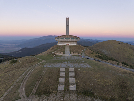 Aerial view of the Buzludzha Monument standing on a mountain peak at sunset in Stara Zagora Bulgaria. Aerial view of the Buzludzha Monument standing on a mountain peak at sunset in Stara Zagora Bulgaria.