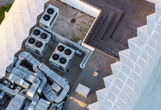 Aerial view of modern medical resort with industrial HVAC units ventilation ducts wooden decking and white geometric mesh facade in Sopot Pomeranian Voivodeship Poland. Aerial view of modern medical resort with industrial HVAC units ventilation ducts wooden decking and white geometric mesh facade in Sopot Pomeranian Voivodeship Poland.
