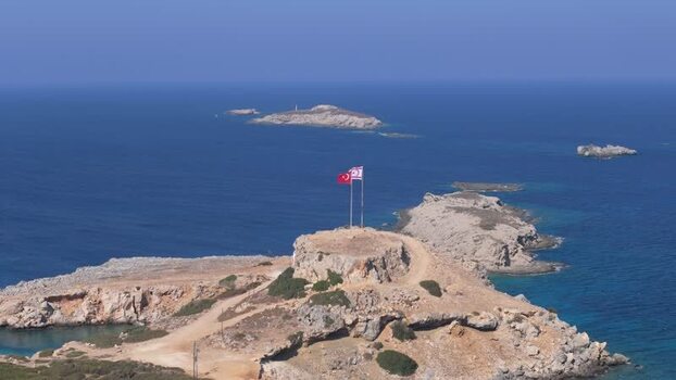 Aerial view of flags on a rocky headland in Famagusta Northern Cyprus.
