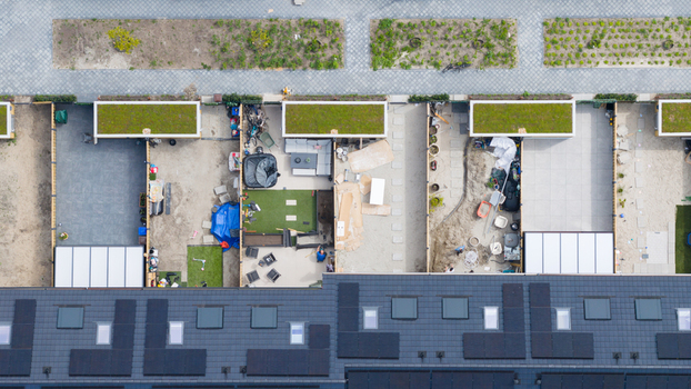 Aerial view of modern terraced houses with solar panels on dark roofs and small backyards featuring green roofed sheds in Utrecht Utrecht Netherlands. Aerial view of modern terraced houses with solar panels on dark roofs and small backyards featuring green roofed sheds in Utrecht Utrecht Netherlands.