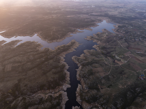 Aerial view of a winding reservoir surrounded by rolling hills and agricultural fields during golden hour in Kirklareli Merkez Kirklareli Turkiye. Aerial view of a winding reservoir surrounded by rolling hills and agricultural fields during golden hour in Kirklareli Merkez Kirklareli Turkiye.