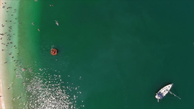 Aerial view of boat and swimmers in the sea Thasos Greece. Aerial view of boat and swimmers in the sea Thasos Greece.