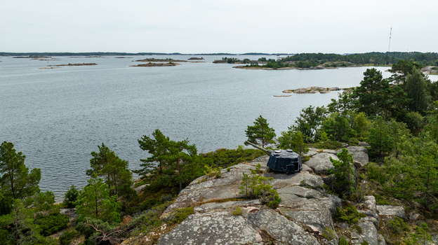 Aerial view of the historic coastal artillery gun at Oro Fortress Island surrounded by rocky terrain pine trees and the Baltic Sea in the archipelago Oro Varsinais Suomi Finland. Aerial view of the historic coastal artillery gun at Oro Fortress Island surrounded by rocky terrain pine trees and the Baltic Sea in the archipelago Oro Varsinais Suomi Finland.