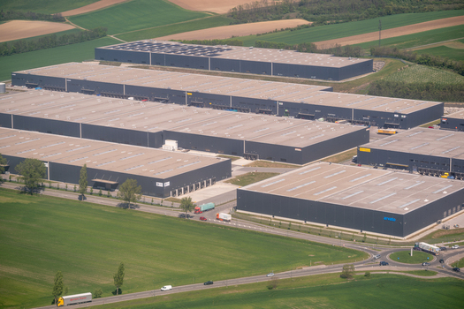 Enzersdorf an der Fischa Austria 24 April 2026 Aerial view of Industrial Campus Vienna East with large modern warehouses solar panels on roofs and surrounding green agricultural fields. Enzersdorf an der Fischa Austria 24 April 2026 Aerial view of Industrial Campus Vienna East with large modern warehouses solar panels on roofs and surrounding green agricultural fields.