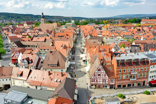 Aerial view of Hauptstrasse with historic half timbered houses red tiled rooftops and the St. Martin church tower Forchheim Bayern Germany.