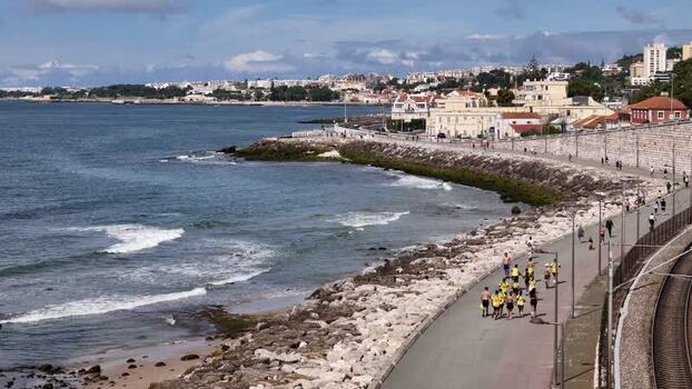 Aerial view of people running along Passeio Maritimo de Alges Portugal. Aerial view of people running along Passeio Maritimo de Alges Portugal.