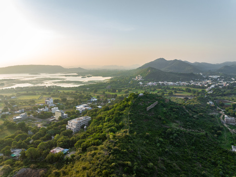 Aerial view of the lush green hills and surrounding landscape near the lakes of Udaipur Rajasthan India.