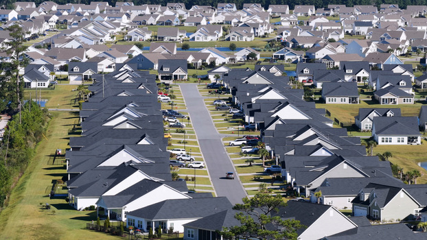 Aerial view of a suburban residential neighborhood with rows of houses paved streets and parked cars in Myrtle Beach South Carolina United States.