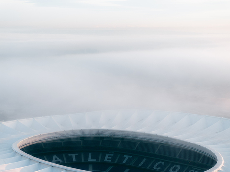 Aerial view of Riyadh Air Metropolitano Stadium partially obscured by thick morning fog in Madrid Comunidad de Madrid Spain.