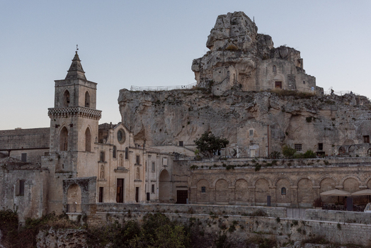 Aerial view of the historic church of San Pietro Caveoso and ancient rock hewn dwellings carved into the limestone cliffs of the Sasso Caveoso district in Matera Basilicata Italy.