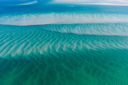 Aerial view of the shallow turquoise waters and intricate sandbar patterns of Moreton Bay near Amity Point Queensland Australia. Aerial view of the shallow turquoise waters and intricate sandbar patterns of Moreton Bay near Amity Point Queensland Australia.