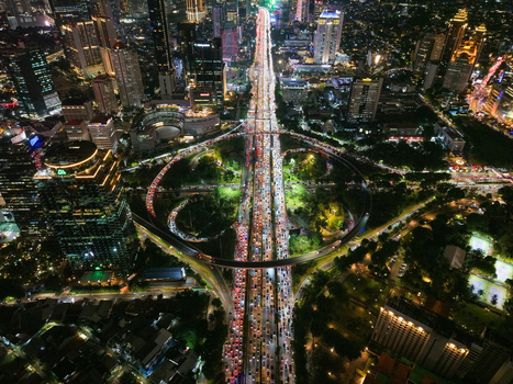 Aerial view of Semanggi Interchange at night with heavy traffic flowing through the illuminated urban landscape of skyscrapers and city lights in Setiabudi Jakarta Indonesia. Aerial view of Semanggi Interchange at night with heavy traffic flowing through the illuminated urban landscape of skyscrapers and city lights in Setiabudi Jakarta Indonesia.