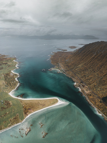 Aerial view of the dramatic coastline and turquoise waters of the Lofoten islands near Svolvaer Nordland Norway.