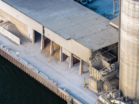 Aerial view of the Zementwerk Berlin concrete facility featuring large storage silos and industrial bays situated along the waterfront in Berlin Berlin Germany. Aerial view of the Zementwerk Berlin concrete facility featuring large storage silos and industrial bays situated along the waterfront in Berlin Berlin Germany.