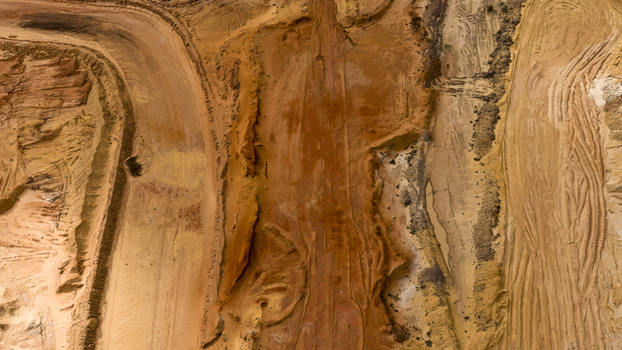 Aerial view of industrial salt mining patterns at Useless Loop showing textured sand and earth in shades of brown and yellow after a storm in Kalbarri Western Australia Australia. Aerial view of industrial salt mining patterns at Useless Loop showing textured sand and earth in shades of brown and yellow after a storm in Kalbarri Western Australia Australia.