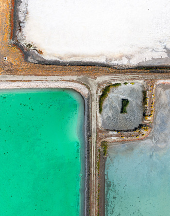 Aerial view of the wastewater evaporation ponds by the Great Salt Lake featuring vibrant turquoise water white salt crusts and earthen dikes in Ogden Utah United States. Aerial view of the wastewater evaporation ponds by the Great Salt Lake featuring vibrant turquoise water white salt crusts and earthen dikes in Ogden Utah United States.