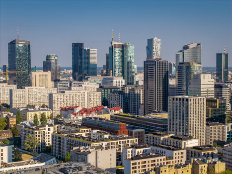 Aerial view of the Warsaw skyline with modern skyscrapers and residential buildings under a clear blue sky Poland. Aerial view of the Warsaw skyline with modern skyscrapers and residential buildings under a clear blue sky Poland.