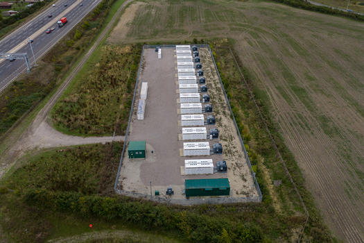 Aerial view of Chapel Farm Energy Park featuring rows of battery storage units and electrical infrastructure situated next to a highway in Luton England United Kingdom. Aerial view of Chapel Farm Energy Park featuring rows of battery storage units and electrical infrastructure situated next to a highway in Luton England United Kingdom.