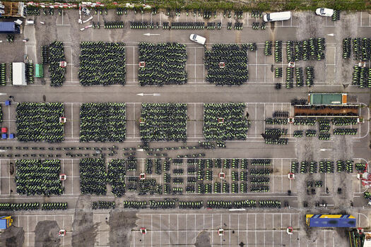 Middenmeer Netherlands 15 June 2026 Aerial view of hundreds of GO Sharing electric scooters parked in neat blocks at a depot in Agriport.