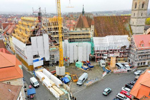 Aerial view of Rathaus Forchheim under renovation with scaffolding and a yellow crane surrounded by historic timber framed buildings in Forchheim Bayern Germany. Aerial view of Rathaus Forchheim under renovation with scaffolding and a yellow crane surrounded by historic timber framed buildings in Forchheim Bayern Germany.