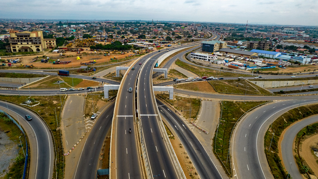 Aerial view of the Tema Motorway interchange with multi level flyovers surrounding urban development and traffic flowing on the highway in Accra Greater Accra Region Ghana. Aerial view of the Tema Motorway interchange with multi level flyovers surrounding urban development and traffic flowing on the highway in Accra Greater Accra Region Ghana.