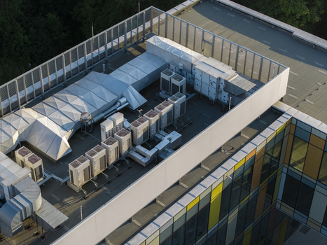 Aerial view of modern building rooftop with multiple HVAC units and ventilation systems in Krakow Lesser Poland Voivode Poland. Aerial view of modern building rooftop with multiple HVAC units and ventilation systems in Krakow Lesser Poland Voivode Poland.